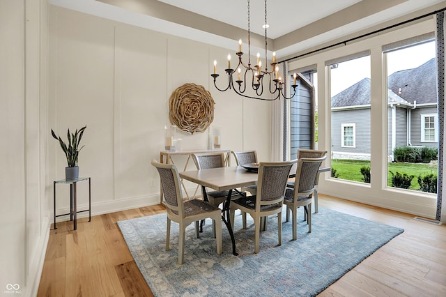 12839 Bird Cage, Carmel, IN 46032 - dining space featuring a chandelier and light wood-style floors