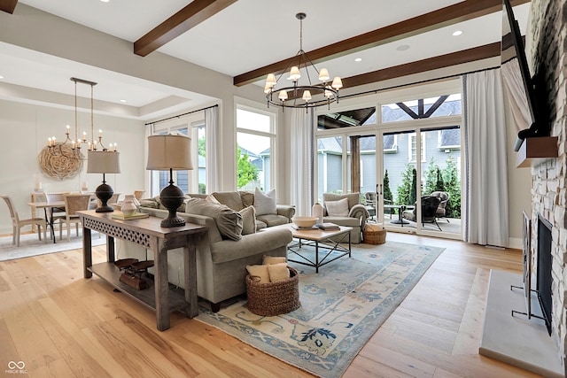 12839 Bird Cage, Carmel, IN 46032 - living area featuring a chandelier, beam ceiling, a stone fireplace, light wood-type flooring, and recessed lighting