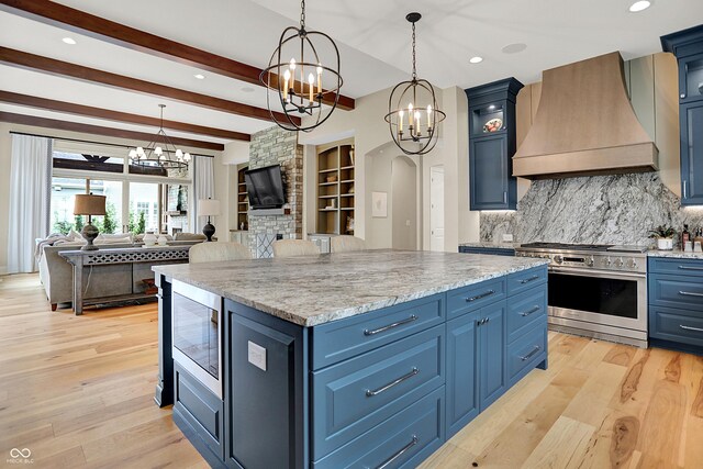 12839 Bird Cage, Carmel, IN 46032 - kitchen with premium range hood, appliances with stainless steel finishes, a chandelier, blue cabinetry, and beamed ceiling