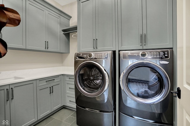 12839 Bird Cage, Carmel, IN 46032 - laundry area with cabinet space, washer and dryer, and tile patterned floors