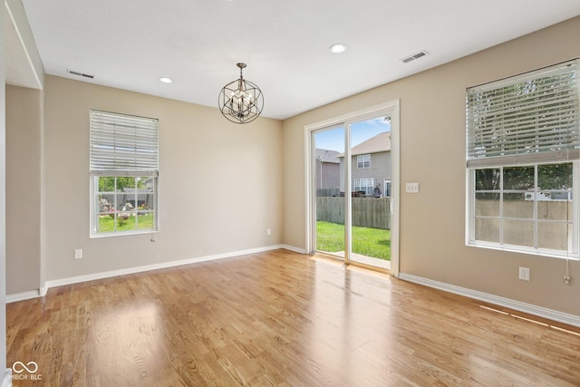 8115 Cole Wood Blvd, Indianapolis, IN 46239 - empty room with a chandelier, wood finished floors, and recessed lighting