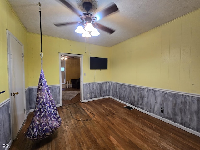 209 N Middle St, Spencer, IN 47460 - spare room featuring ceiling fan, hardwood / wood-style floors, a textured ceiling, and wainscoting