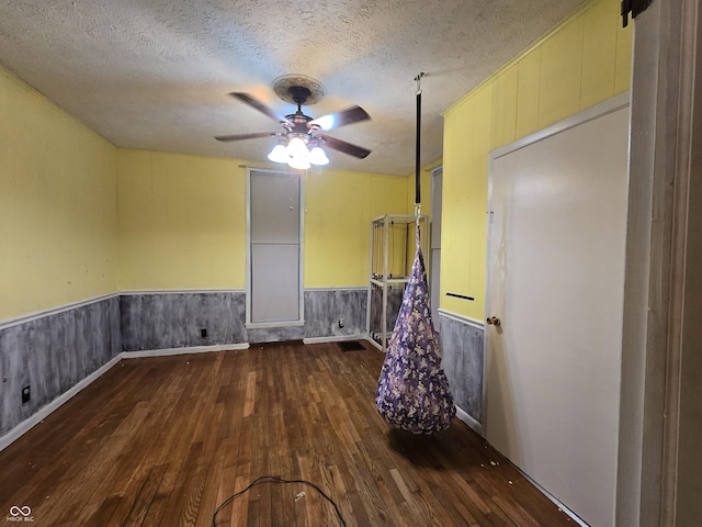 209 N Middle St, Spencer, IN 47460 - spare room featuring hardwood / wood-style flooring, a ceiling fan, a textured ceiling, and wainscoting