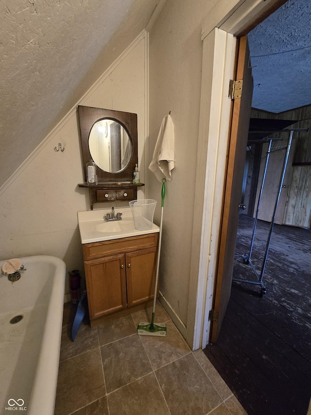 209 N Middle St, Spencer, IN 47460 - full bath with a soaking tub, vanity, vaulted ceiling, and a textured ceiling