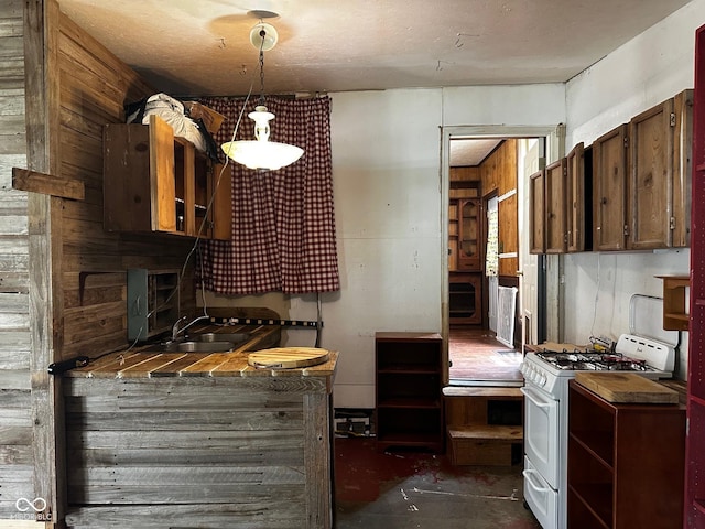 209 N Middle St, Spencer, IN 47460 - kitchen featuring white range with gas stovetop, concrete flooring, hanging light fixtures, and open shelves