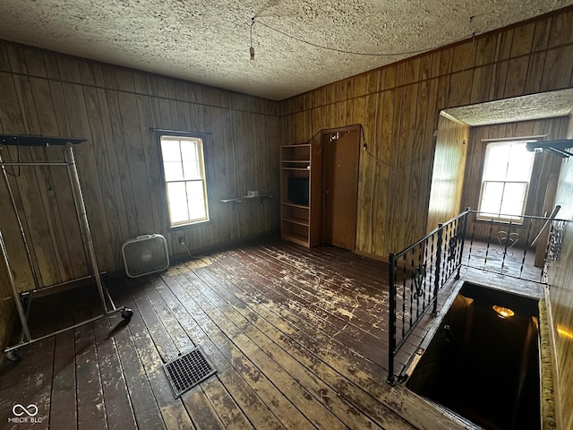 209 N Middle St, Spencer, IN 47460 - empty room with wood-type flooring, wood walls, and a textured ceiling