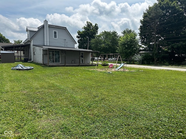 209 N Middle St, Spencer, IN 47460 - back of house featuring a playground, a lawn, and a chimney