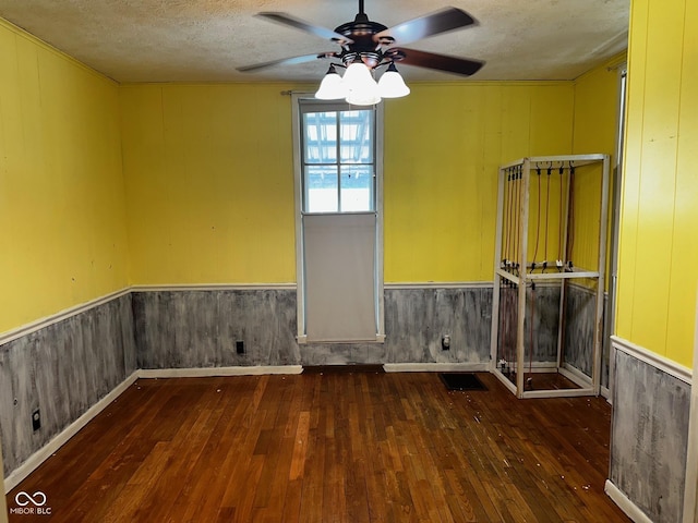 209 N Middle St, Spencer, IN 47460 - spare room with hardwood / wood-style floors, a ceiling fan, a wainscoted wall, and a textured ceiling