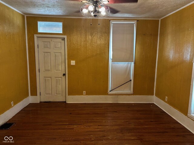 209 N Middle St, Spencer, IN 47460 - empty room with a textured ceiling, wood finished floors, ornamental molding, ceiling fan, and wood walls