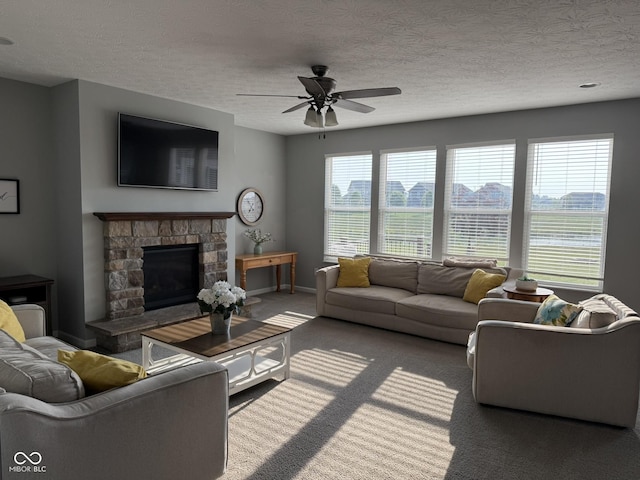 15961 Foothill Dr, Noblesville, IN 46060 - carpeted living room with ceiling fan, a stone fireplace, and a textured ceiling