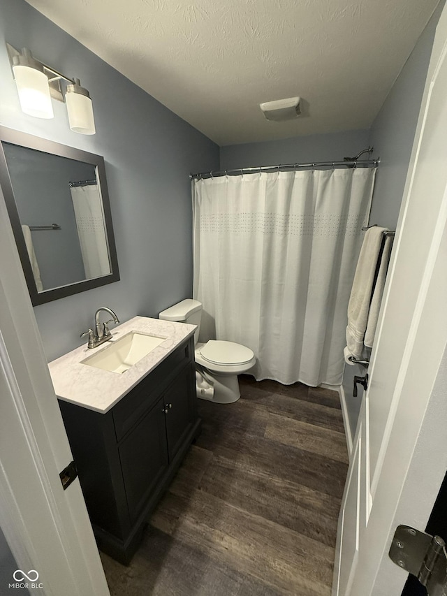 15961 Foothill Dr, Noblesville, IN 46060 - full bathroom featuring vanity, wood finished floors, a textured ceiling, and curtained shower