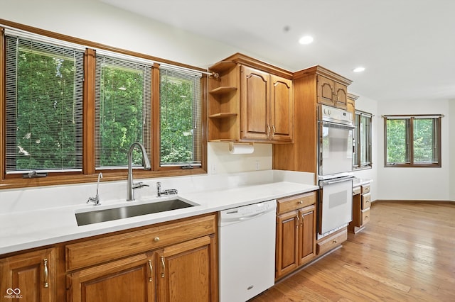 1326 Pebble Brook Dr, Noblesville, IN 46062 - kitchen featuring white appliances, light countertops, light wood-style floors, brown cabinetry, and recessed lighting