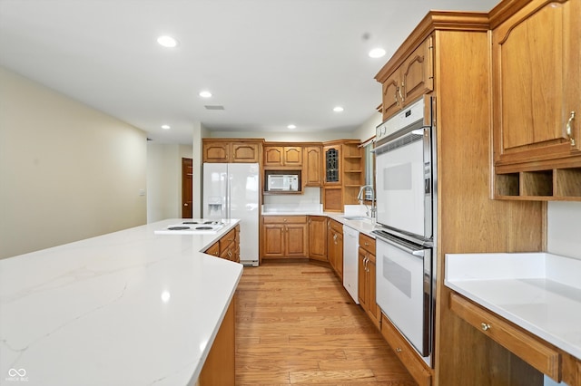 1326 Pebble Brook Dr, Noblesville, IN 46062 - kitchen with white appliances, open shelves, light wood-style floors, light countertops, and recessed lighting