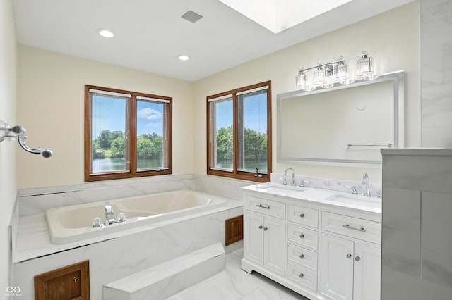 1326 Pebble Brook Dr, Noblesville, IN 46062 - bathroom featuring a garden tub, double vanity, a skylight, and recessed lighting