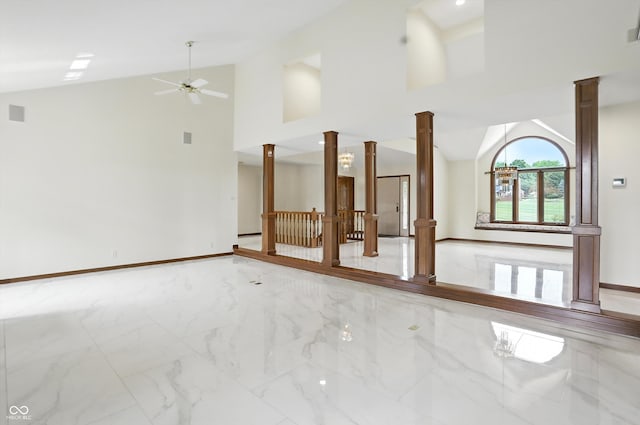 1326 Pebble Brook Dr, Noblesville, IN 46062 - unfurnished living room featuring decorative columns, marble finish flooring, ceiling fan, and high vaulted ceiling
