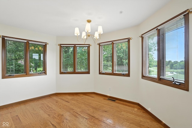 1326 Pebble Brook Dr, Noblesville, IN 46062 - empty room with a chandelier and wood finished floors