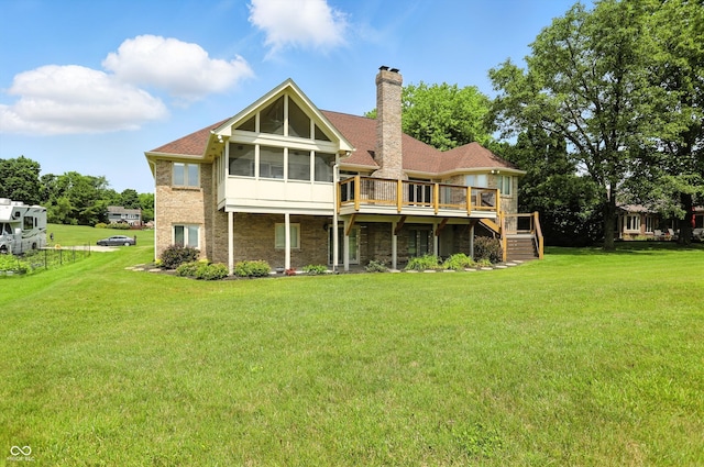 1326 Pebble Brook Dr, Noblesville, IN 46062 - rear view of house with a sunroom, a chimney, a wooden deck, and a lawn