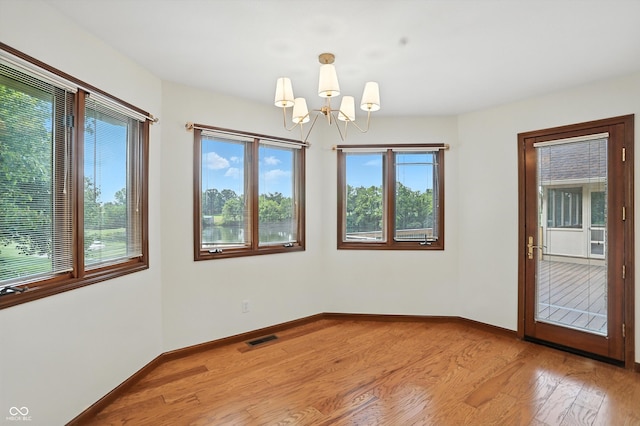 1326 Pebble Brook Dr, Noblesville, IN 46062 - unfurnished room with a chandelier and light wood finished floors