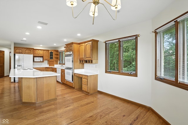1326 Pebble Brook Dr, Noblesville, IN 46062 - kitchen with white appliances, light wood-type flooring, brown cabinets, recessed lighting, and light countertops