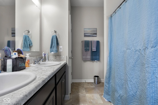 2421 Creek Bank Dr, Columbus, IN 47201 - bathroom with double vanity and baseboards
