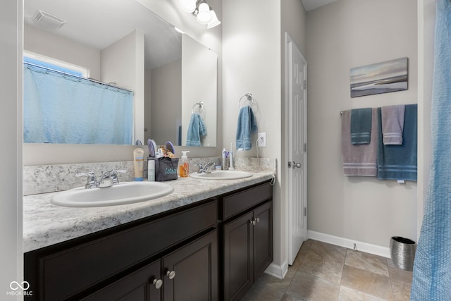 2421 Creek Bank Dr, Columbus, IN 47201 - bathroom featuring double vanity and tile patterned flooring