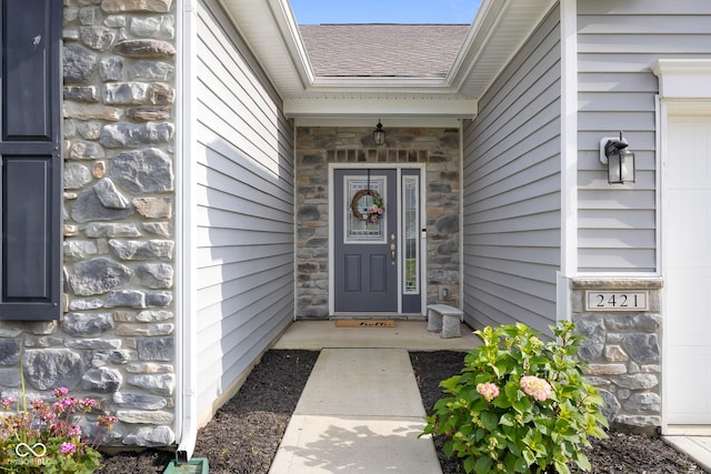 2421 Creek Bank Dr, Columbus, IN 47201 - doorway to property featuring stone siding and a shingled roof