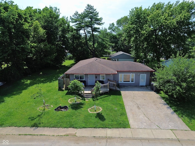 2610 Caroline Ave, Indianapolis, IN 46218 - view of front of home with concrete driveway, a deck, and a front yard