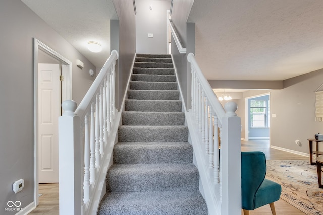 2289 Salem Park Dr, Indianapolis, IN 46239 - stairway with a textured ceiling and wood finished floors