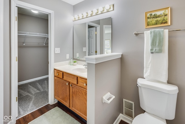 2289 Salem Park Dr, Indianapolis, IN 46239 - bathroom with vanity, wood finished floors, and a spacious closet