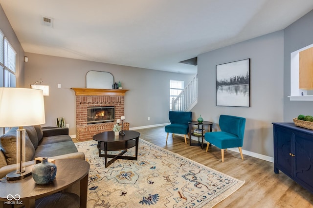 2289 Salem Park Dr, Indianapolis, IN 46239 - living area with light wood finished floors, stairway, and a fireplace