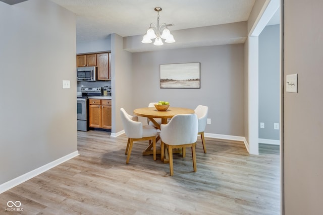 2289 Salem Park Dr, Indianapolis, IN 46239 - dining space with a chandelier and light wood-type flooring