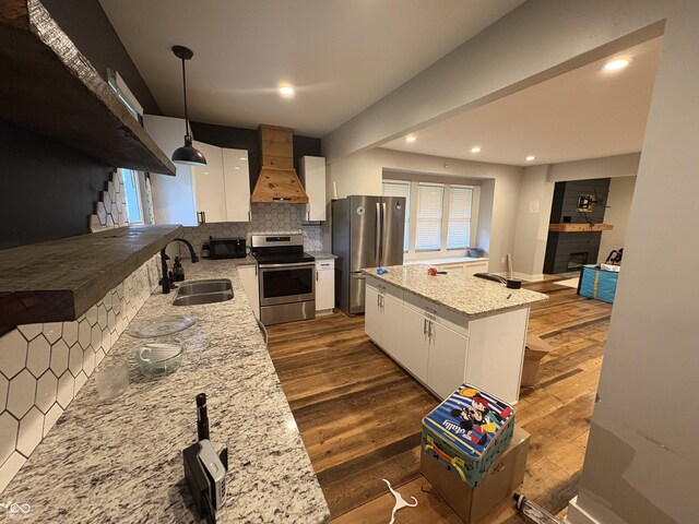 917 N Rural St, Indianapolis, IN 46201 - kitchen with stainless steel appliances, custom exhaust hood, dark wood-type flooring, decorative backsplash, and recessed lighting
