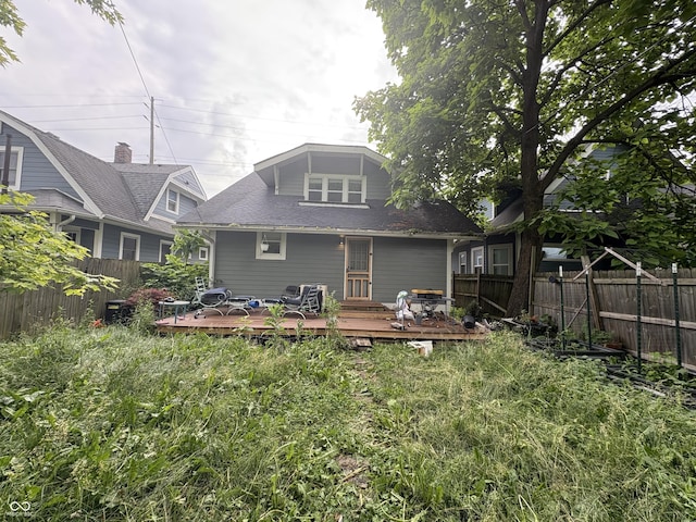 917 N Rural St, Indianapolis, IN 46201 - back of house with a fenced backyard, a wooden deck, and roof with shingles