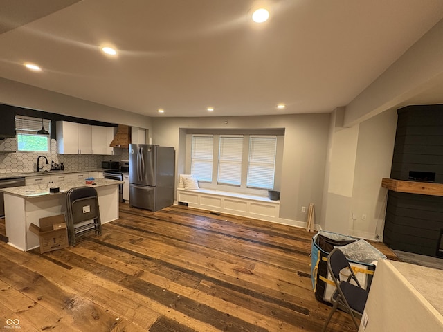 917 N Rural St, Indianapolis, IN 46201 - kitchen with stainless steel appliances, wall chimney exhaust hood, dark wood-style floors, tasteful backsplash, and recessed lighting