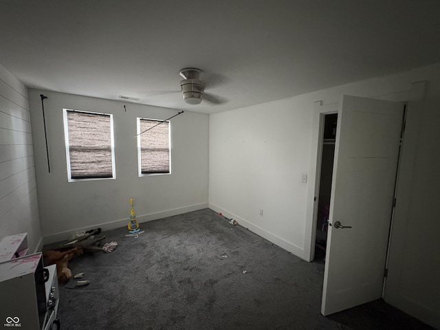 917 N Rural St, Indianapolis, IN 46201 - unfurnished bedroom featuring dark carpet and ceiling fan
