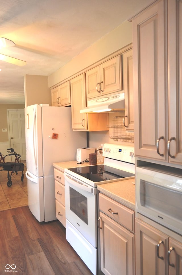 3115 E 400 S, Anderson, IN 46017 - kitchen with white appliances, under cabinet range hood, light countertops, a ceiling fan, and dark wood finished floors