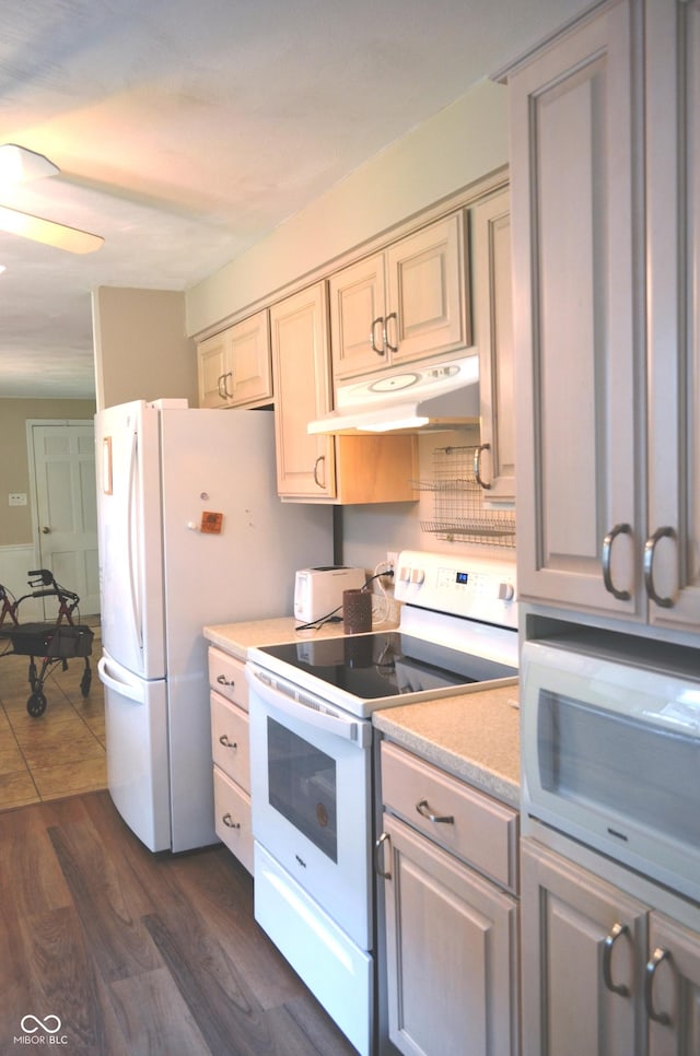 3115 E 400 S, Anderson, IN 46017 - kitchen featuring white appliances, under cabinet range hood, light countertops, dark wood-style flooring, and ceiling fan