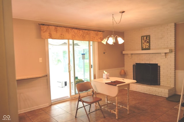 3115 E 400 S, Anderson, IN 46017 - tiled dining space with a chandelier, a brick fireplace, and wainscoting