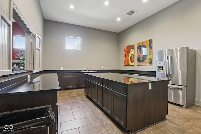 2105 Granville Dr, Westfield, IN 46074 - kitchen featuring stainless steel fridge, dark countertops, a center island, recessed lighting, and dark brown cabinets