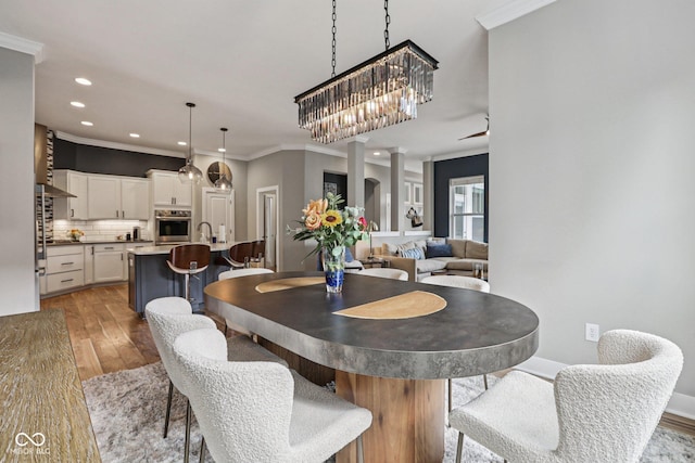 2105 Granville Dr, Westfield, IN 46074 - dining area with wood finished floors, ornamental molding, recessed lighting, and a chandelier