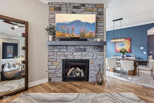 2105 Granville Dr, Westfield, IN 46074 - living area featuring crown molding, wood finished floors, a fireplace, and a chandelier
