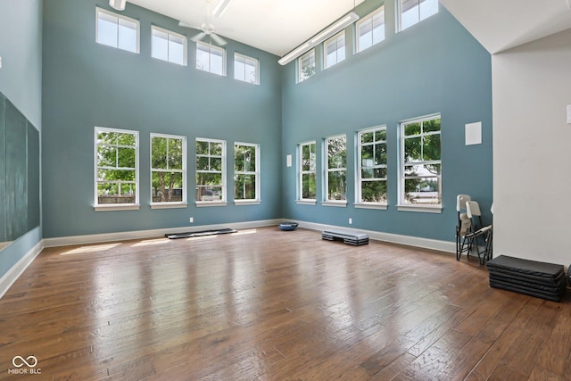 2105 Granville Dr, Westfield, IN 46074 - unfurnished living room featuring a towering ceiling, ceiling fan, and hardwood / wood-style floors
