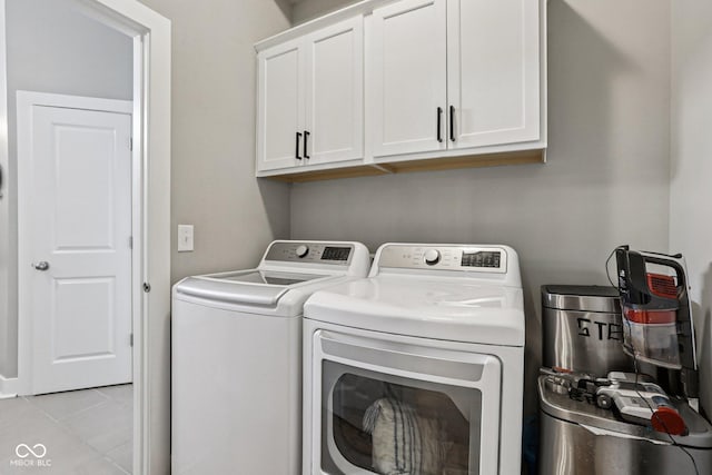2105 Granville Dr, Westfield, IN 46074 - laundry area with cabinet space, washing machine and dryer, and light tile patterned flooring
