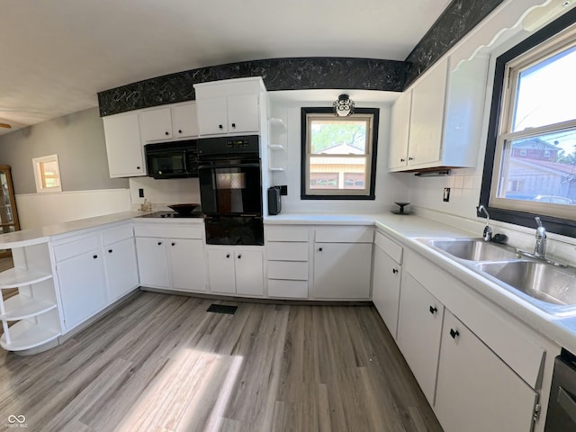 771 Doran Ave, Shelbyville, IN 46176 - kitchen with open shelves, black appliances, a warming drawer, white cabinets, and light wood-style floors