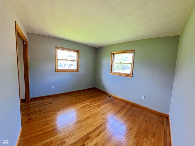 771 Doran Ave, Shelbyville, IN 46176 - unfurnished bedroom with light wood-style flooring, a closet, and a textured ceiling