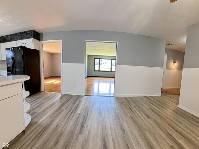 771 Doran Ave, Shelbyville, IN 46176 - kitchen featuring open floor plan, light wood-type flooring, white cabinetry, light countertops, and black fridge