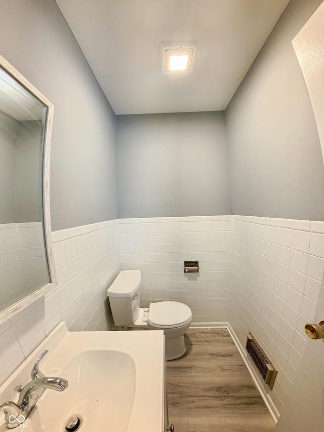 771 Doran Ave, Shelbyville, IN 46176 - half bathroom featuring tile walls, wood finished floors, vanity, and wainscoting