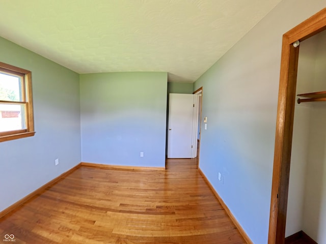 771 Doran Ave, Shelbyville, IN 46176 - unfurnished bedroom featuring light wood finished floors, a closet, and a textured ceiling