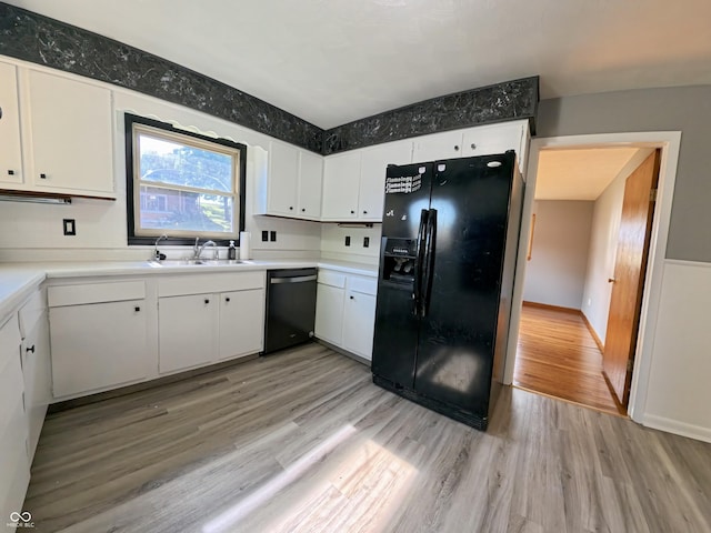 771 Doran Ave, Shelbyville, IN 46176 - kitchen with black fridge, dishwasher, light wood-style floors, and white cabinetry