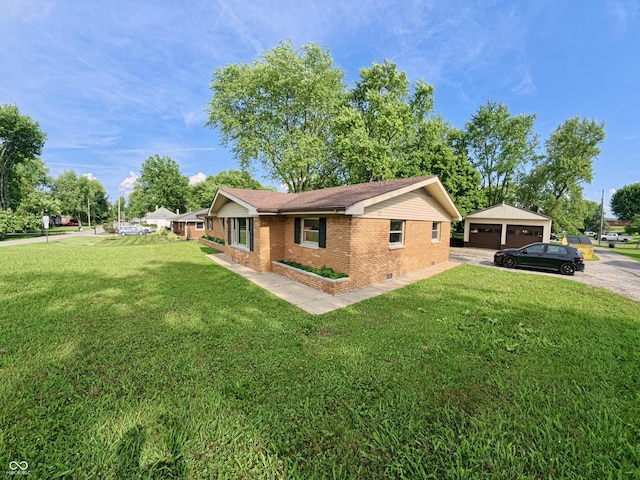 771 Doran Ave, Shelbyville, IN 46176 - view of side of property featuring brick siding, a detached garage, a yard, and an outbuilding